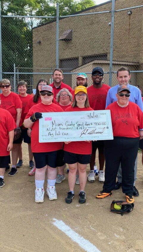 staff-community-holding-large-donation-check Chevrolet of Troy in Troy OH